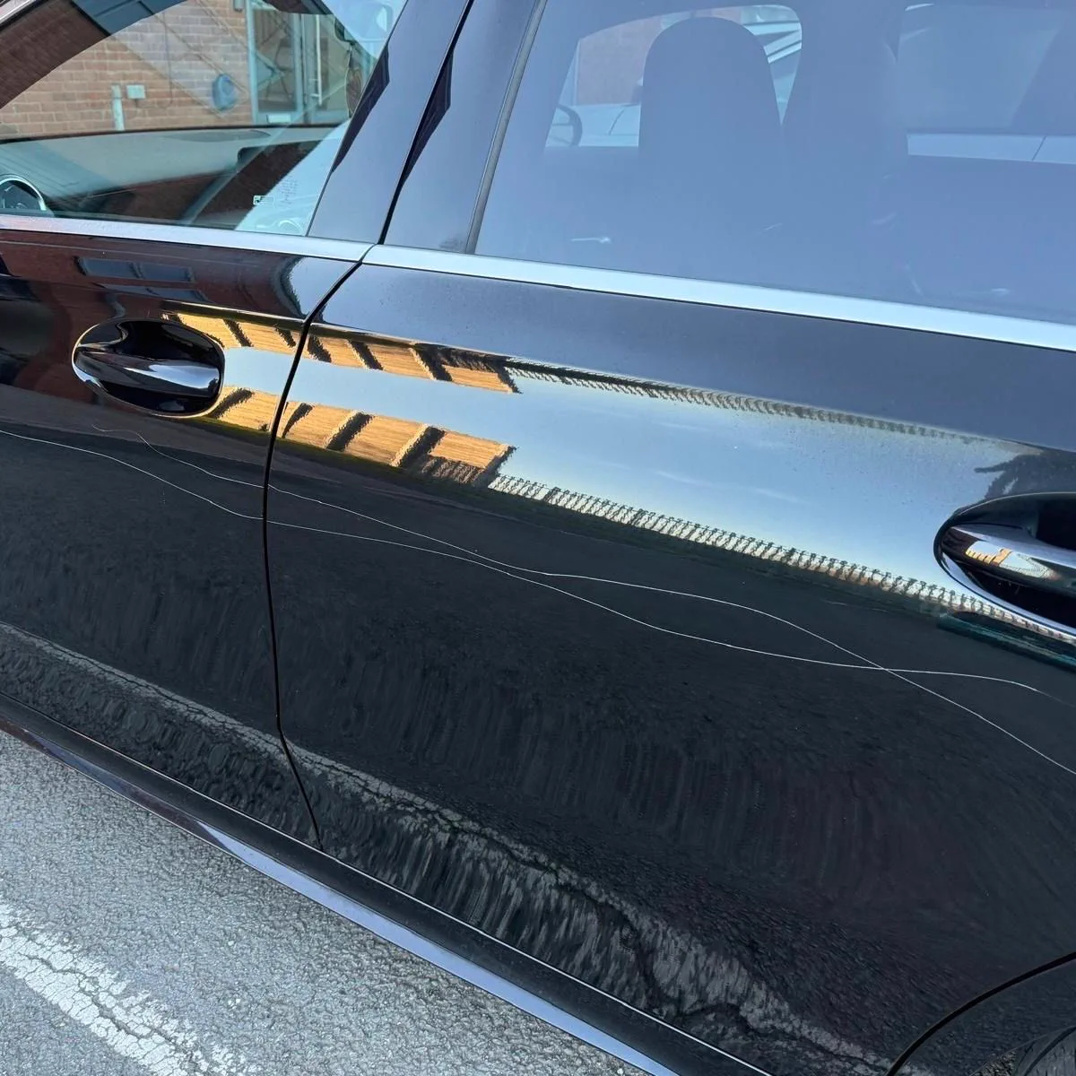 Black door scratch repair before repair