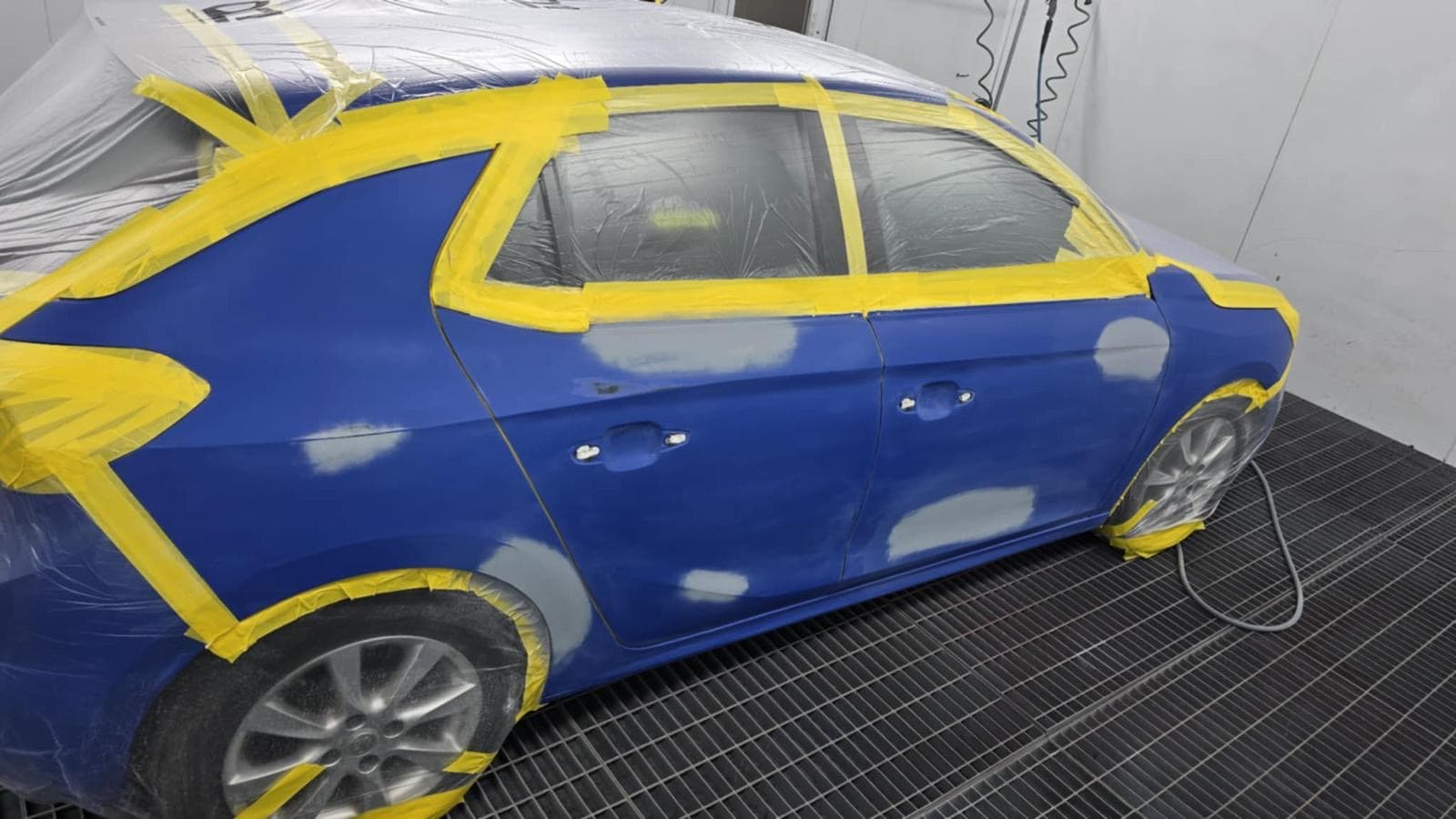 Vehicle receiving professional dent repair in the workshop